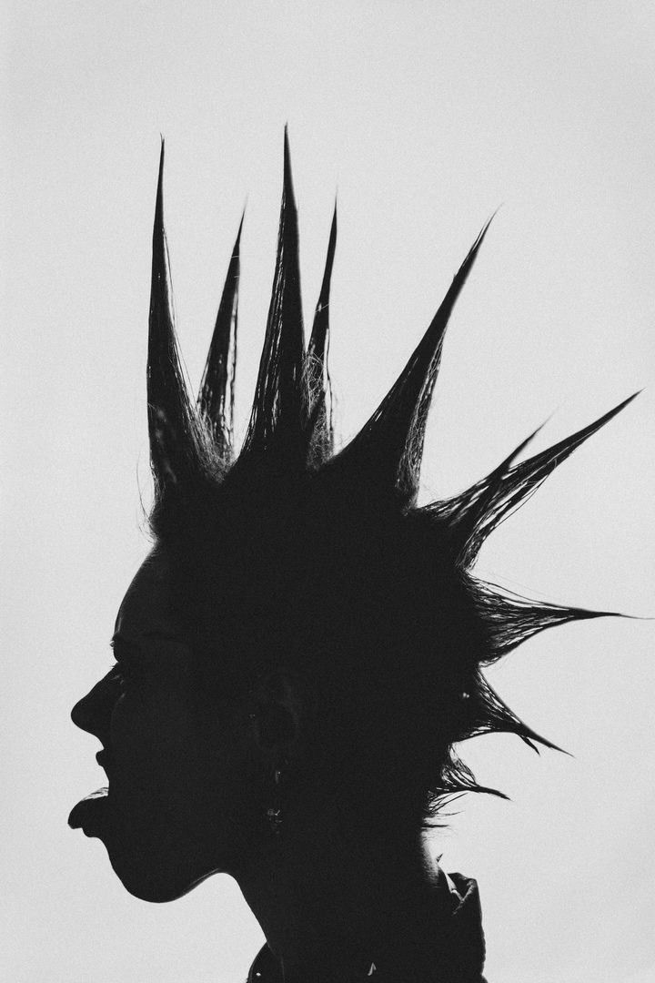 black and white photograph of a person with spiked hair