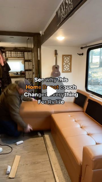 two men moving couches in a living room next to a window with the words see why ths home changed everything for rv life