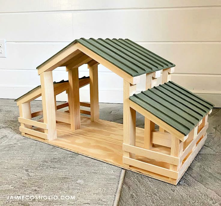 two wooden dog houses sitting on top of a wood floor