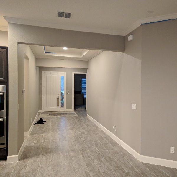 an empty living room with hard wood flooring and white trim on the walls is shown