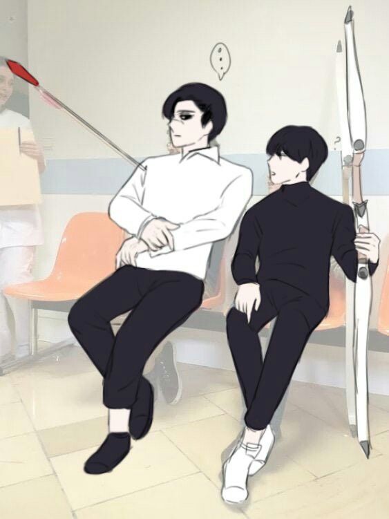 two people are sitting on the floor with one holding a golf club and another standing behind them