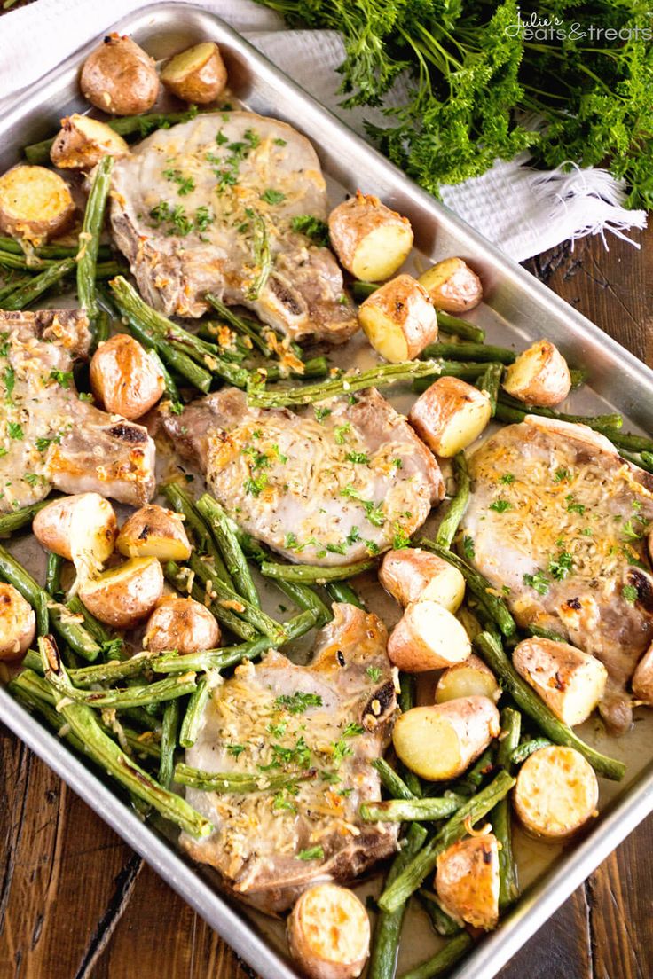 sheet pan pork chops and veggies on a wooden table