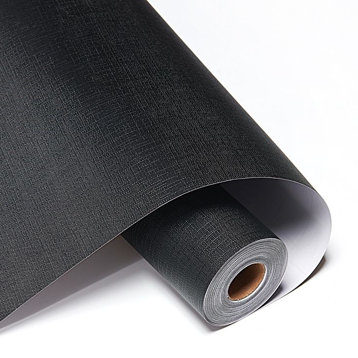 a roll of black paper on top of a white surface