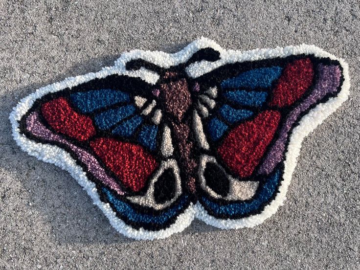 a close up of a butterfly patch on the ground with no one in it's image