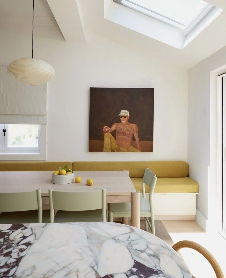 a dining room table with two chairs and a painting on the wall above it that has an image of a woman sitting in a bathrobat