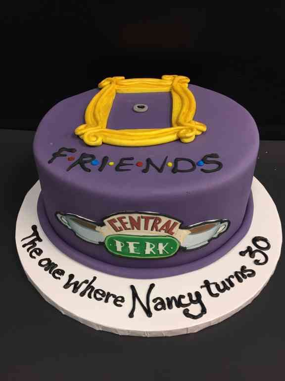 there is a purple cake that says friends central perk here where nancy turns 30