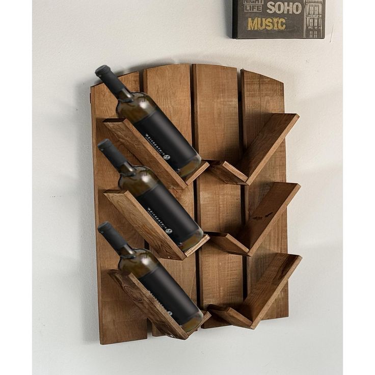 a wooden wine rack with three bottles on it