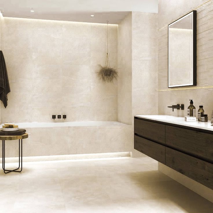 a bathroom with a sink, mirror and bathtub next to a wall mounted faucet