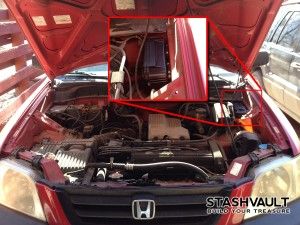 the engine compartment of a honda car is shown with its hood open and wires exposed