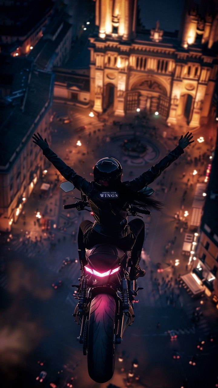 a person on a motorcycle with their arms outstretched in the air above a city at night