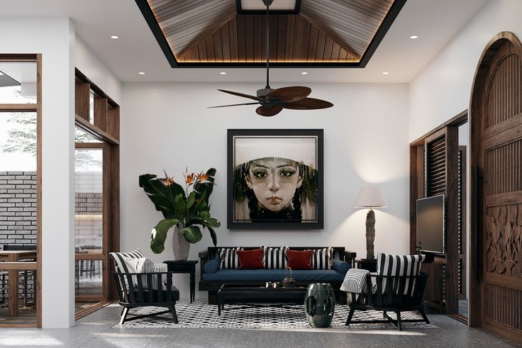 a living room filled with furniture and a painting hanging on the wall above it's doorway