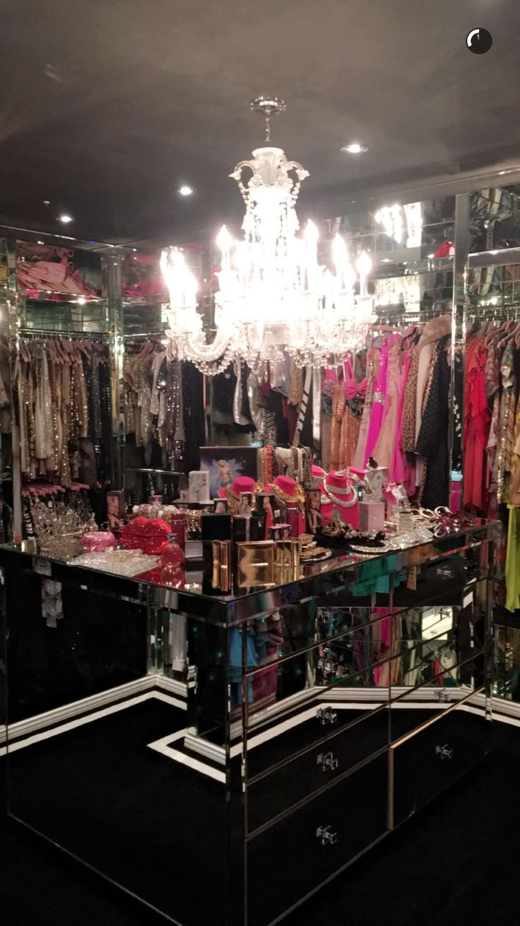 a clothing store filled with lots of clothes and chandelier