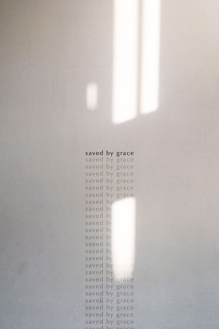 a white wall with the words saved by grace written on it