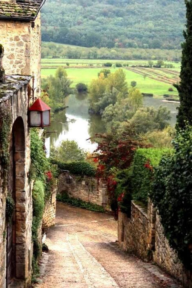 an alley way leading to a river in the countryside