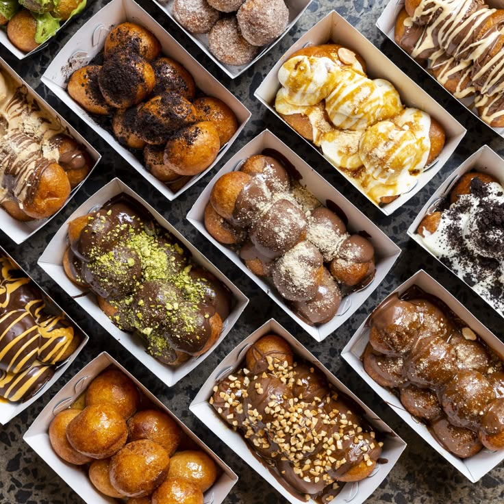 many different types of pastries in boxes