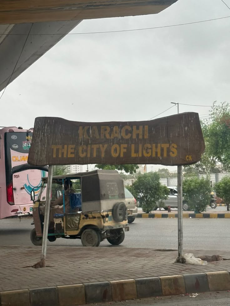 a sign that says march the city of lights in front of a truck and bus