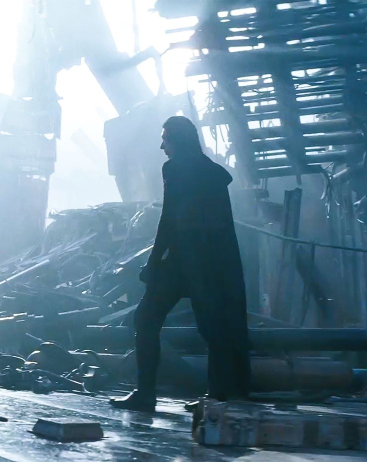 a man standing in front of a pile of rubble