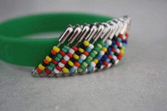 a green bracelet with multicolored beads on it