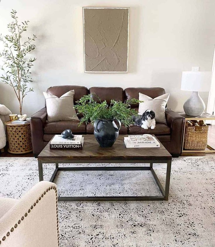 a living room with two couches and a coffee table in front of a painting