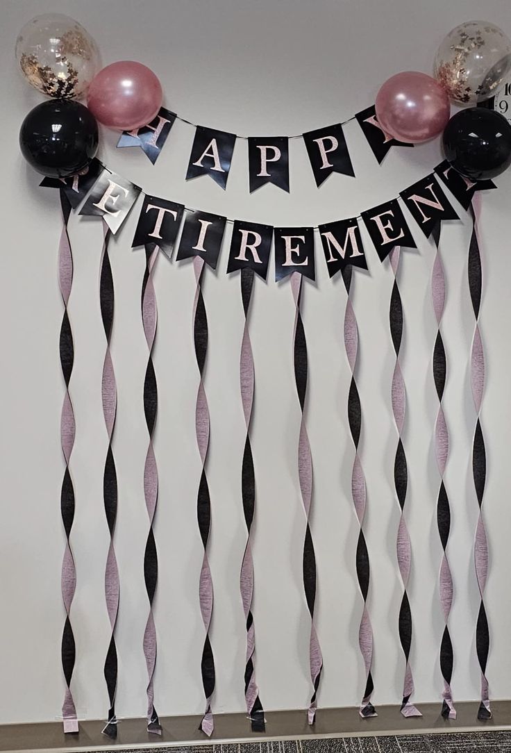 a happy retirement banner with balloons and streamers