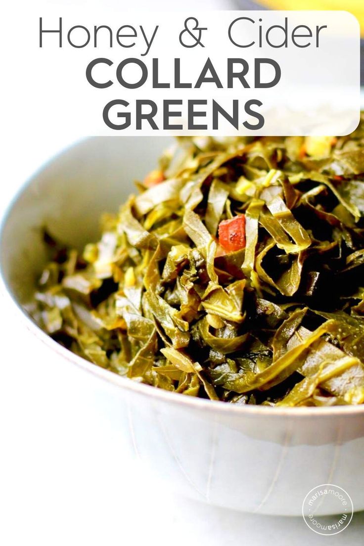 a white bowl filled with collard greens on top of a table