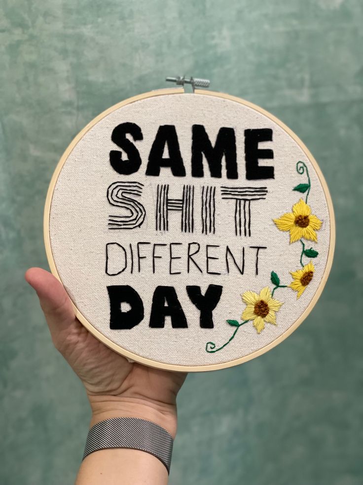 someone is holding up a cross - stitch pattern with the words same different day on it