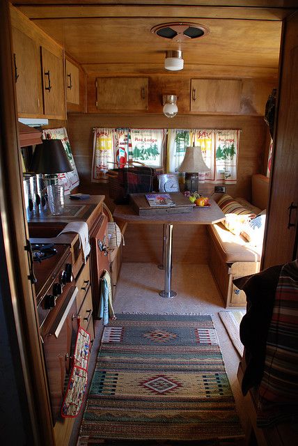 the inside of a small home with wood paneling