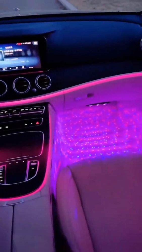 the interior of a car with purple lights on it's dash board and dashboard