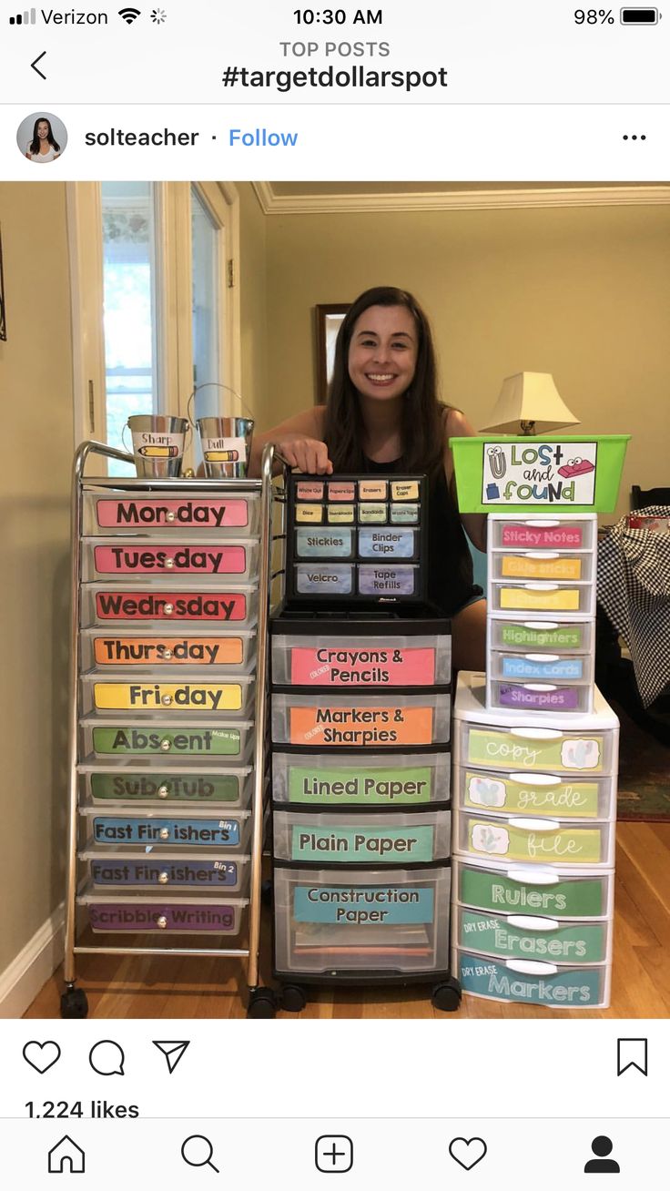 a woman standing in front of a stack of plastic containers filled with different types of labels