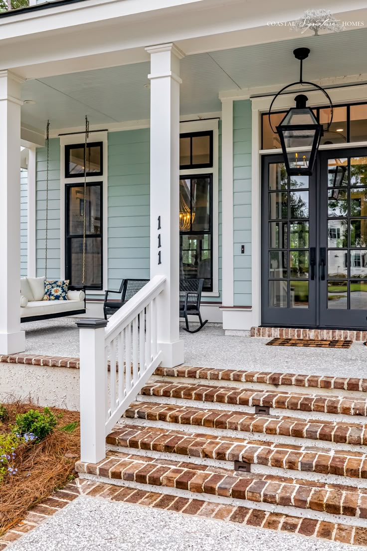 a porch with steps leading up to the front door