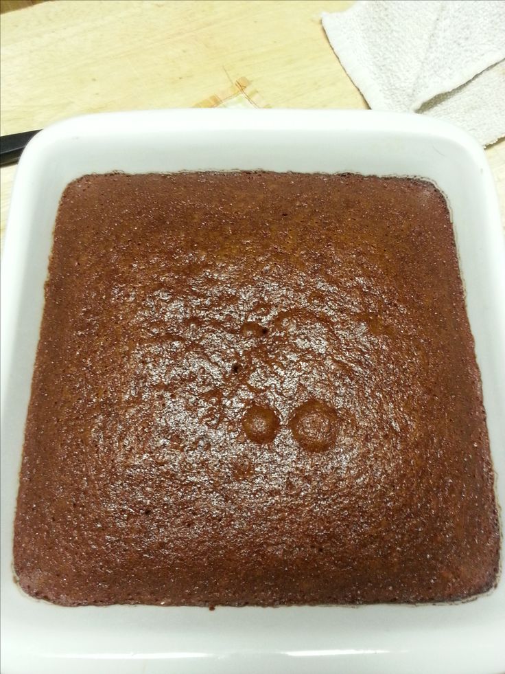 a square brownie in a white bowl on a table