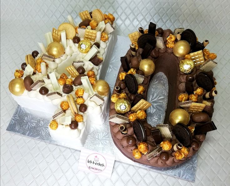 two cakes decorated with chocolate and gold decorations