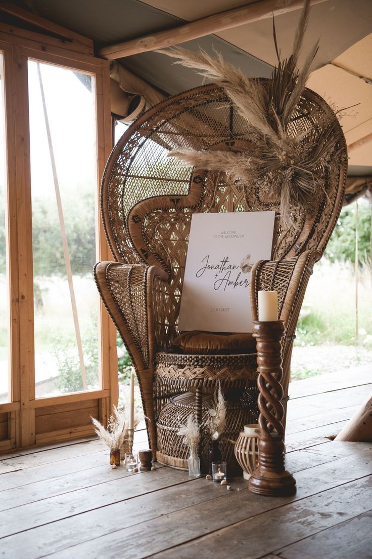 a wicker chair with a sign on it sitting in front of an open window