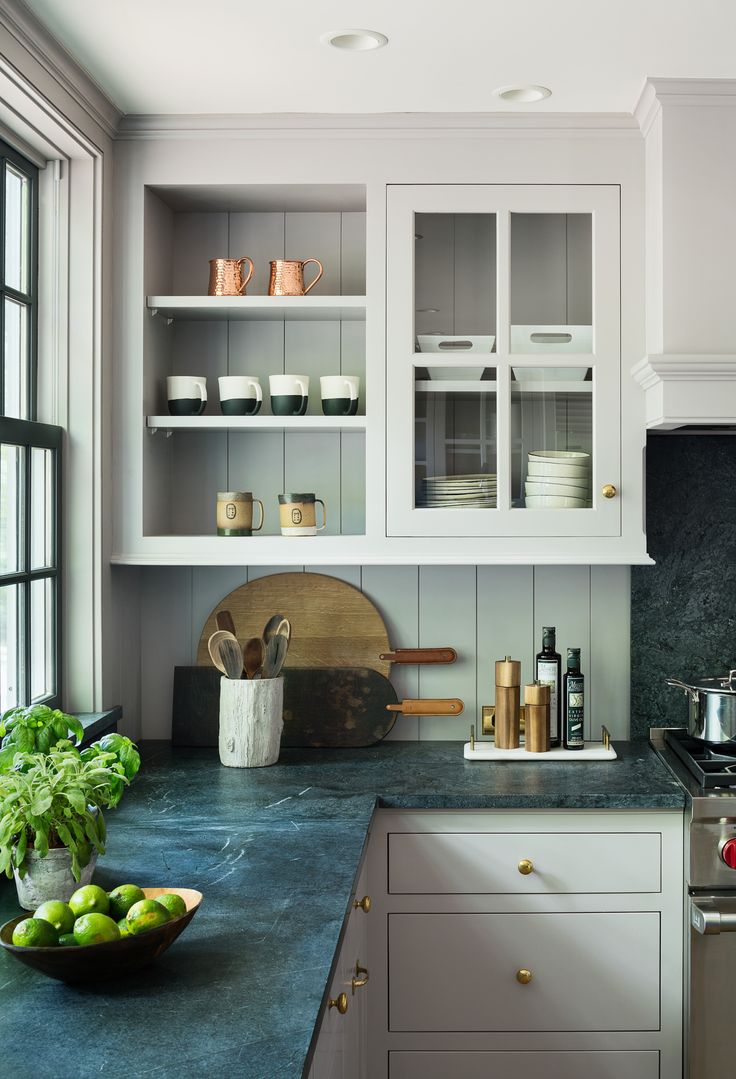 a kitchen with white cabinets and blue counter tops