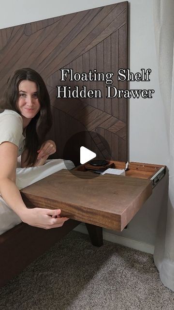 a woman sitting on top of a bed next to a wooden headboard with the words floating shelf hidden drawer