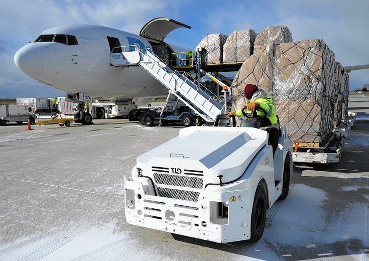 a man loading cargo onto an airplane on the tarmac