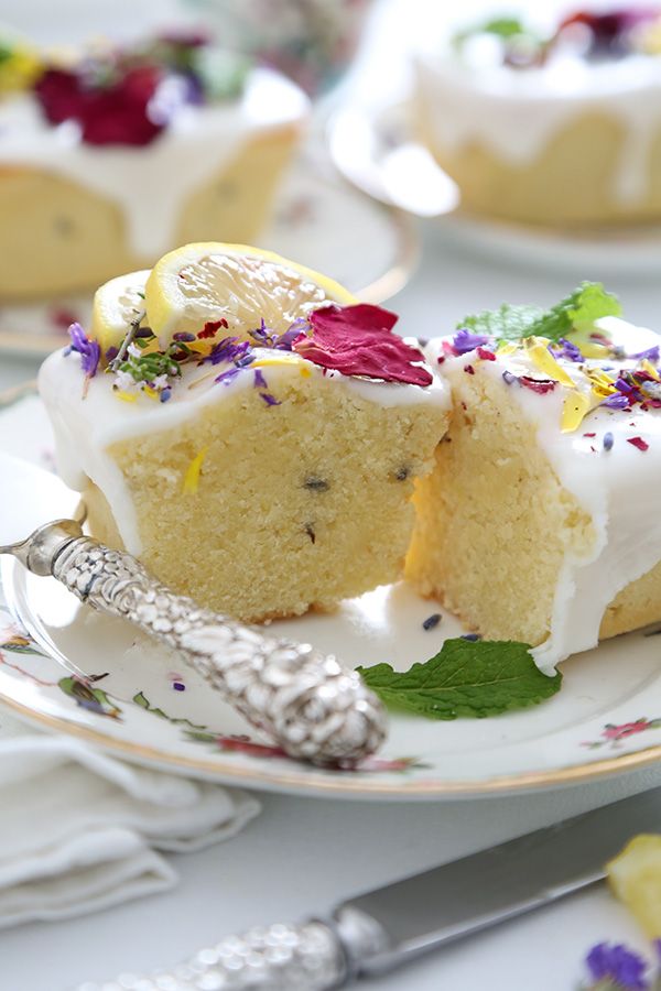 a piece of cake with white frosting and colorful flowers on the top is sitting on a plate