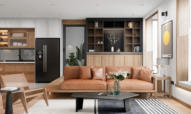 a living room filled with furniture next to a kitchen