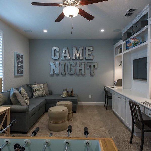 a living room filled with furniture and a ceiling fan