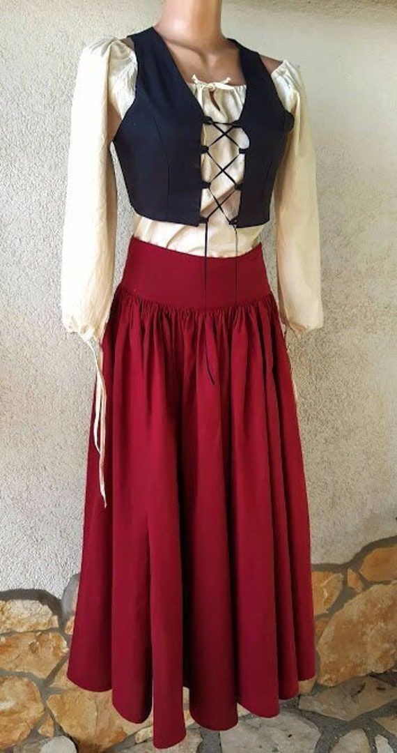 This medieval traditional dress is made of 100% cotton canvas. In accordance with the requirements of the medieval, without buttons and zippers, they close with lacing solutions everywhere. The outfit consists of the following parts: 1 piece long sleeve cotton blouse 1 long canvas skirt in a color of your choice 1 short vest in a color of your choice The dress is made to order in advance, with a deadline of at least two weeks, based on the following data: shoulders, bust, waist, hips, body heigh Medieval Costume Skirt, Medieval Fitted Skirt For Larp, Peasant Dresses For Medieval Festivals, Gothic Medieval Dress For Medieval Festivals, Cotton Dresses For Larp, Peasant Dresses For Larp, Fitted Prairie Dress Costume For Medieval Festivals, Fitted Prairie Dress For Larp And Medieval Festivals, Gothic Fitted Cotton Skirt