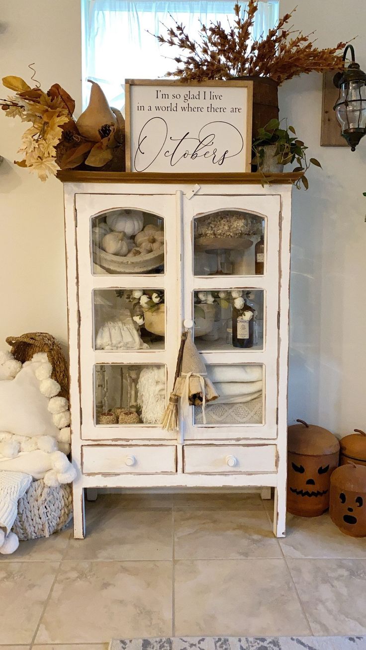 an old china cabinet is decorated with pumpkins