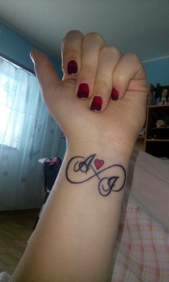 a woman's arm with a tattoo on it that says love and two hearts