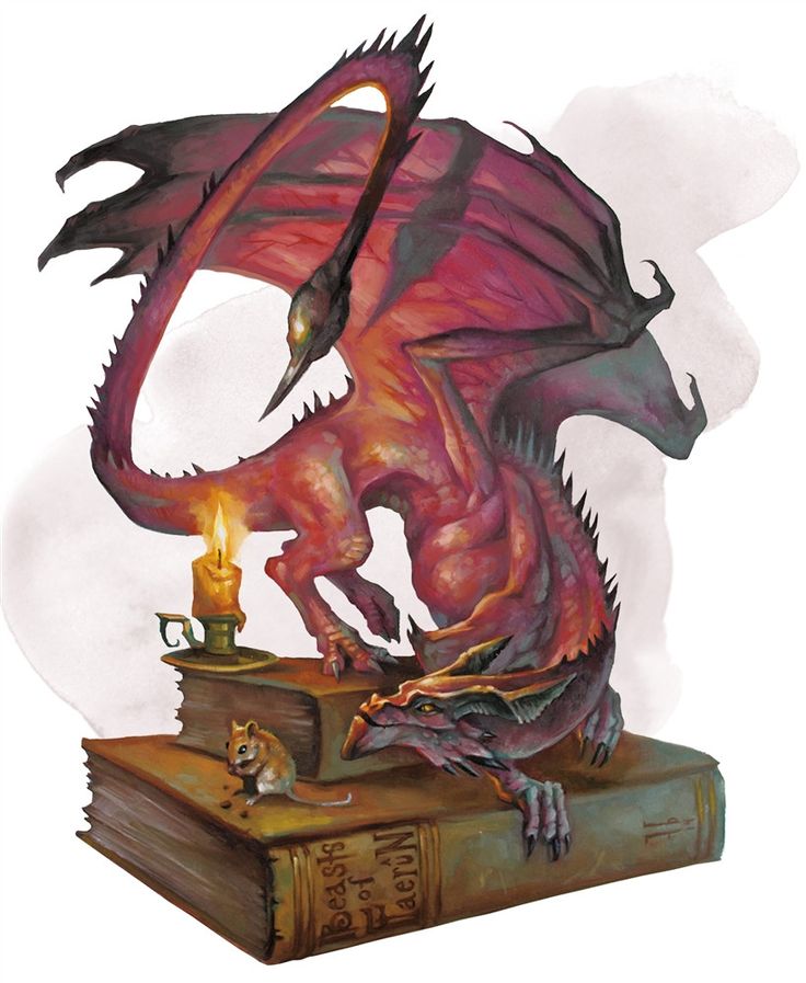 a red dragon sitting on top of a book next to a candle and a cup