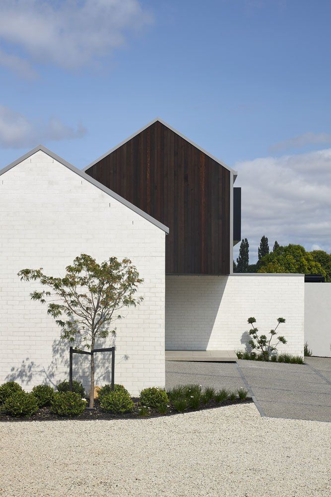 a white building with a tree in front of it