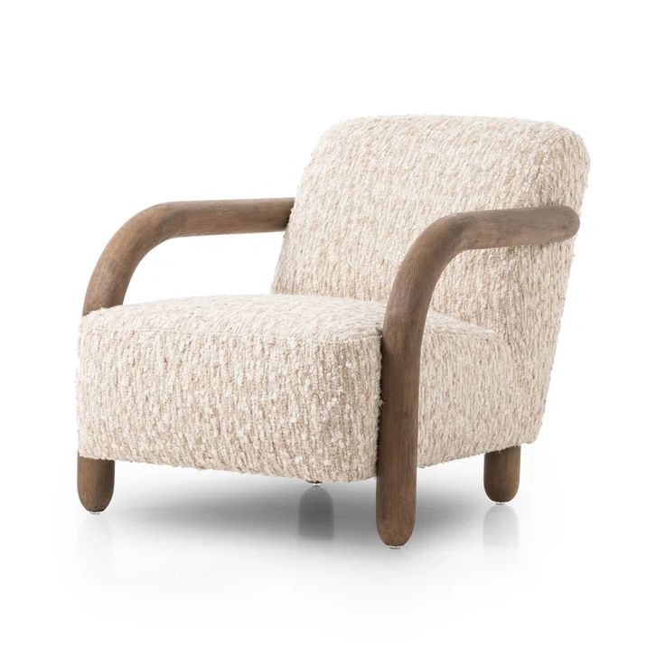 a white chair with wooden legs and a beige upholstered arm rest on a white background