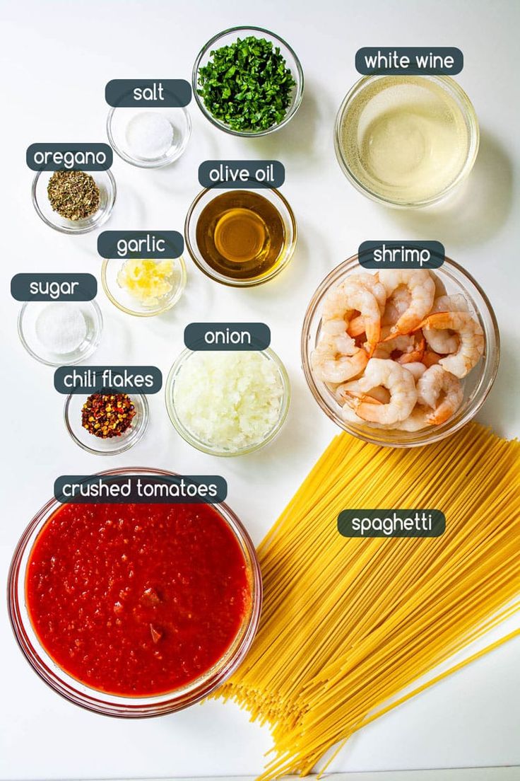 the ingredients to make shrimp pasta laid out on a white surface with text overlay