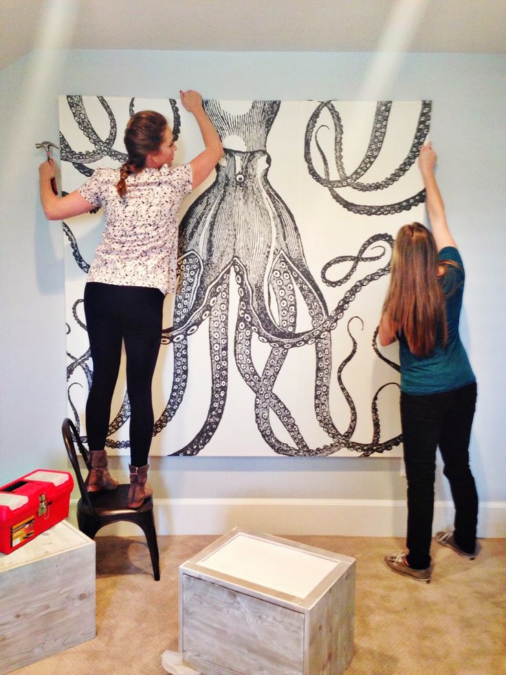 two women are working on an octopus painting