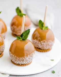 small desserts are arranged on a plate with toothpicks sticking out of them