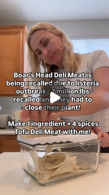 a woman is making some food in a glass container on the kitchen counter with words above it