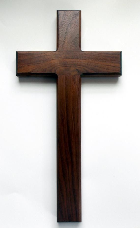 a wooden cross hanging on the wall